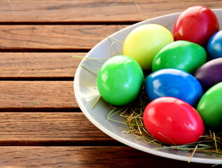 Colorful boiled easter eggs on a wooden table