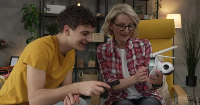 Mother and son adjust and install home cctv video surveillance camera