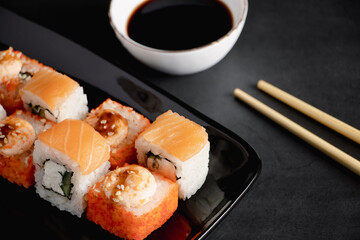 Set of sushi roll on black plate. Serving Japanese food in restaurant.
