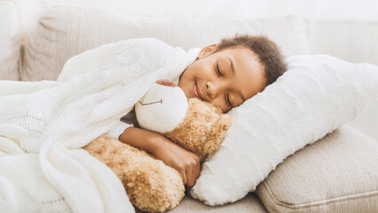 Adorable little girl sleeping in bed with her toy