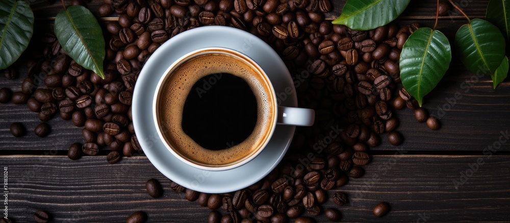 Wall mural a cup of kopi luwak coffee sits on a wooden table, surrounded by coffee beans, leaves, and dandelion