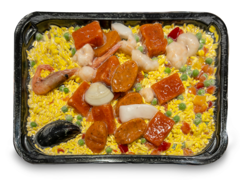 Paella with rice and precooked ingredients vacuum-packed and frozen in tray, isolated