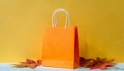 empty orange color shopping bag on the yellow background design creative concept for autumn sale...