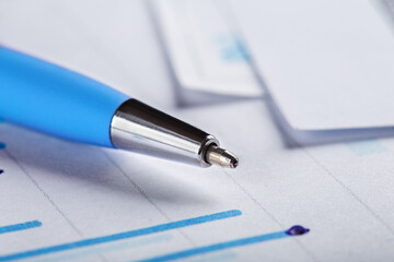 Accounting document with pen, money, coins and checking financial chart. Concept of banking,...