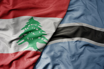 big waving national colorful flag of botswana and national flag of lebanon.