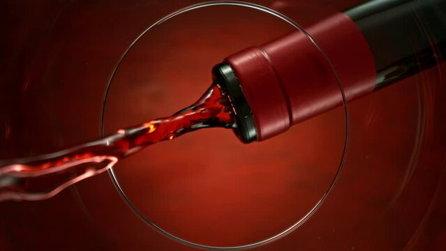 Super Slow Motion of Pouring Red Wine into Glass. Unique Perspective Composition from Bottom of the Glass. Filmed on High Speed Cinema Camera, 1000 fps.