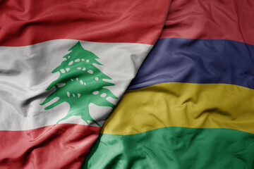 big waving national colorful flag of mauritius and national flag of lebanon.