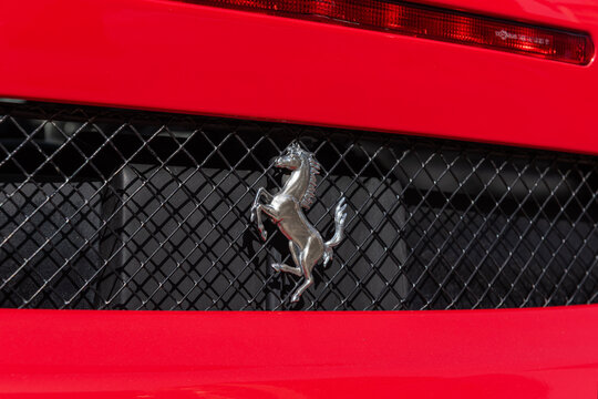 ISTANBUL, TURKEY - MARCH 13, 2024:  A close-up of the Ferrari logo on a red car with drops of water. The Scuderia Ferrari team was founded by Enzo Ferrari in 1929.