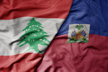 big waving national colorful flag of haiti and national flag of lebanon.