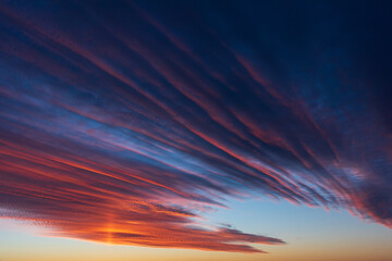 Stunningly beautiful multi-colored violet-pink-lilac evening sky, multi-colored clouds fan out from the lower horizon