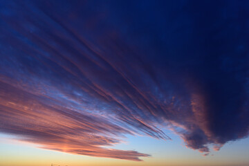 Obraz premium Stunningly beautiful multi-colored violet-pink-lilac evening sky, multi-colored clouds fan out from the lower horizon