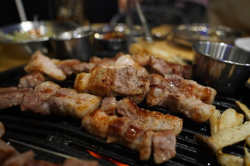 Grilled pork belly on the grill in the restaurant