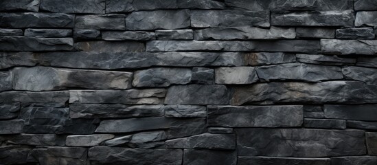 A detailed view of a grey brick stone wall made out of composite materials, showcasing the intricate brickwork and durability of the building material