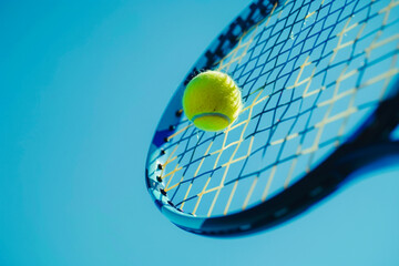 Close up of a tennis racket on a sunny summer day