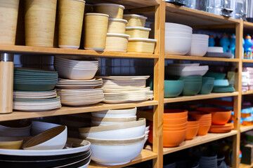 Shelf with colorful ceramic plates for sell in a tableware store