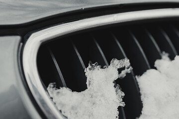 gray passenger car during snowy winter, snowy ventilation grilles of the front of the car (cele - obrazy, fototapety, plakaty