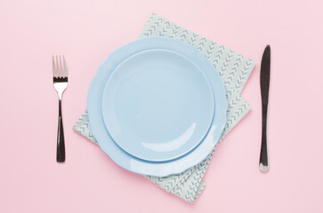 Minimal table setting on color background, top view