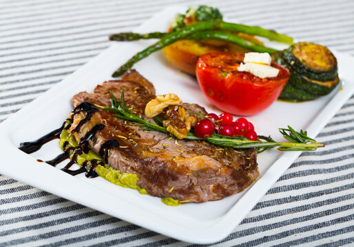 Veal with baked vegetables is tasty dish in the kitchen.
