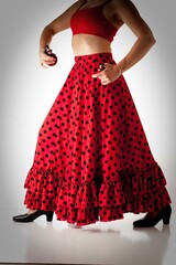 Flamenco dancer from the waist to shoes with castanets isolated on white background.