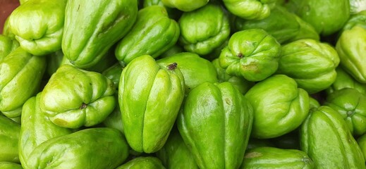 Heap fresh green chayote vegetables or labu siam ready sold in traditional market in Indonesia