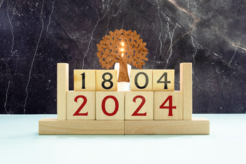 April 18, Cover design with number cube on a white background and granite table.
