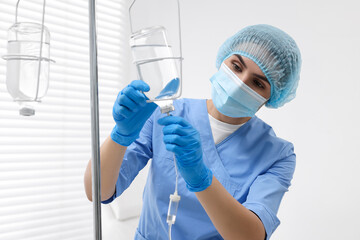 Nurse setting up IV drip in hospital