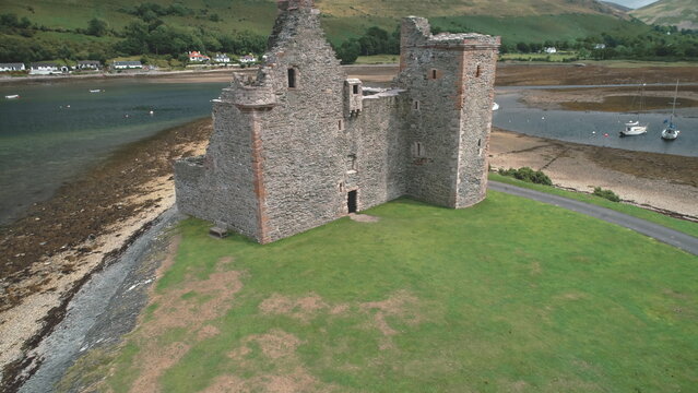 Ancient castle ruins aerial shot on Loch Ranza bay. Historical monument and heritage of British culture. Amazing scenery on Arran Island, Scotland, UK, Europe. Footage view