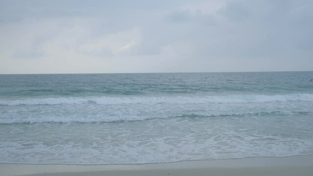 waves of the ocean and gray cloudy.