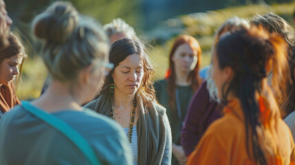 A group of people stand in a circle their eyes closed as they visualize and channel the power of their Qi into a collective healing circle. - obrazy, fototapety, plakaty
