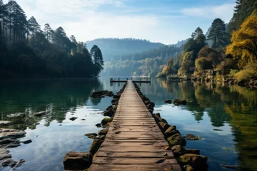 Gardinen Wooden dock over water, surrounded by trees in natural landscape © Yuchen Dong