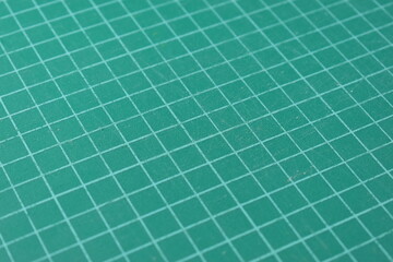 green cutting mat board background with line and scale measure guide pattern for object art design, tool equipment of diy craft work