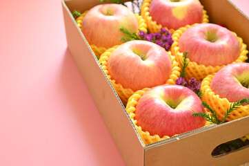 beautiful apple in the box on pink backgrond, healthy fruit