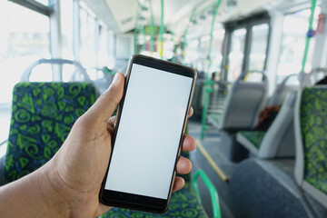 passenger sitting in a bus using his phone.