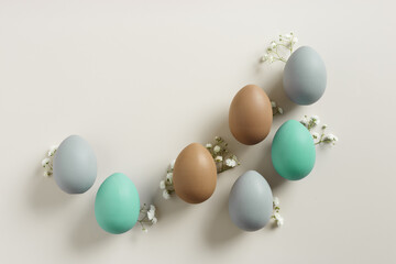 Elegant Easter Composition with Pastel Eggs and Spring Blossoms, still life Dyed eggs in soft...