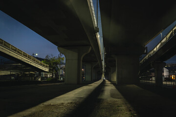 Light shining under a viaduct in Japan.