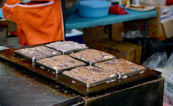 Closeup of Crazy snacks, Coconut pancake, Thai coconut pancakes desserts name in thai Kanom babin on a hot pan at market street food Thailand.
