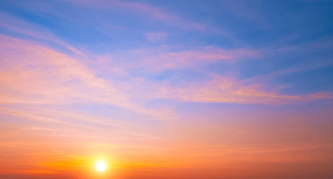 Colorful sunrise sky in the morning with orange sunlight clouds on idyllic horizontal sky background. Beautiful sunset in golden hour time