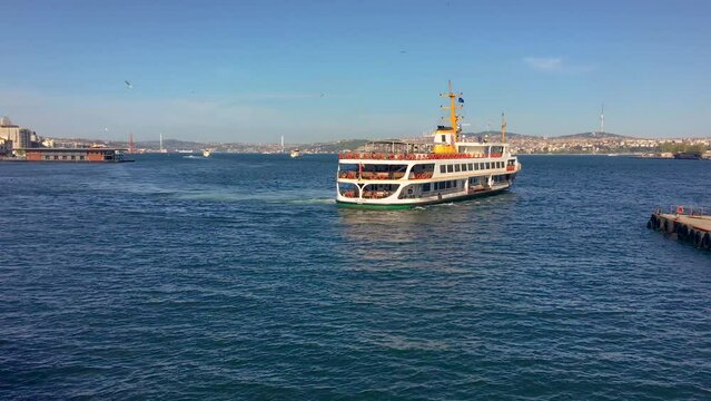 A ferry in Istanbul cruising the Bosporus on a sunny day.