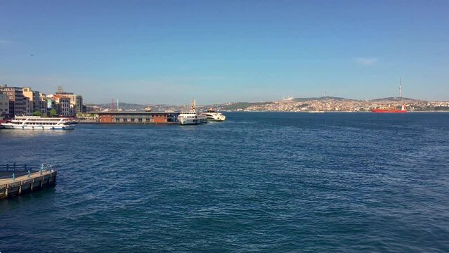 A ferry in Istanbul cruising the Bosporus on a sunny day.