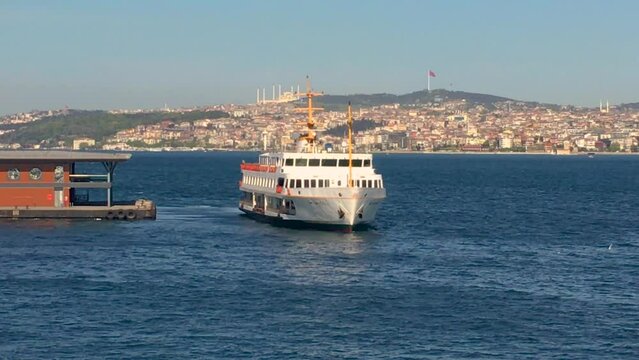A ferry in Istanbul cruising the Bosporus on a sunny day.