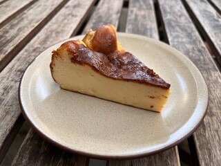 piece of cake. Classic baked cheesecake serving on the plate. Famous sweet dessert menu in bakery shop.