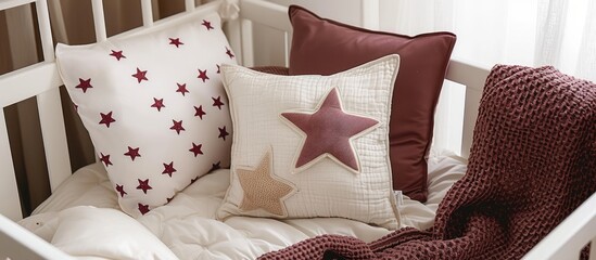Baby crib with white and Burgundy pillows and starry blanket from above. - obrazy, fototapety, plakaty