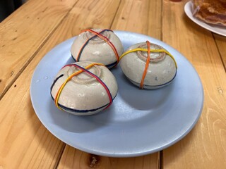 Traditional Coconut milk custard in small porcelain cup. Famous local sweet dessert in Thai restaurant.