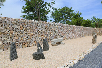 Decoration stone against stone wall with steel bar for background. Perspective view. - 761950806