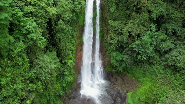 Drone footage of Gitgit waterfall on rainy day. Bali, Indonesia.