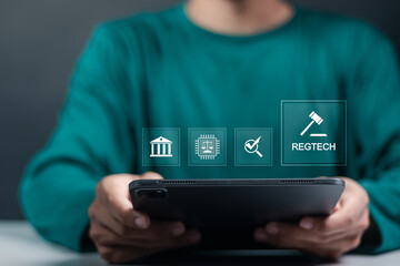 RegTech concept, regulation compliance financial control. Person use tablet with regtech icon on virtual screen.