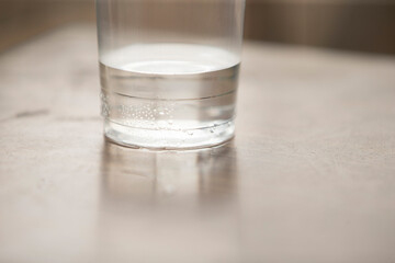 Glass of clean water table, shallow depth of field.