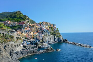 Wander through a picturesque coastal town, where colorful buildings perch on cliffs overlooking the...