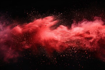 Abstract explosion of red dust on black background. Abstract red powder splatter on dark background. Freeze motion of red powder splash.