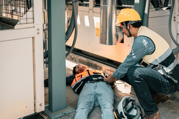 Asian HVAC engineer injured on job, needs urgent aid and support. Pain conveys distress.